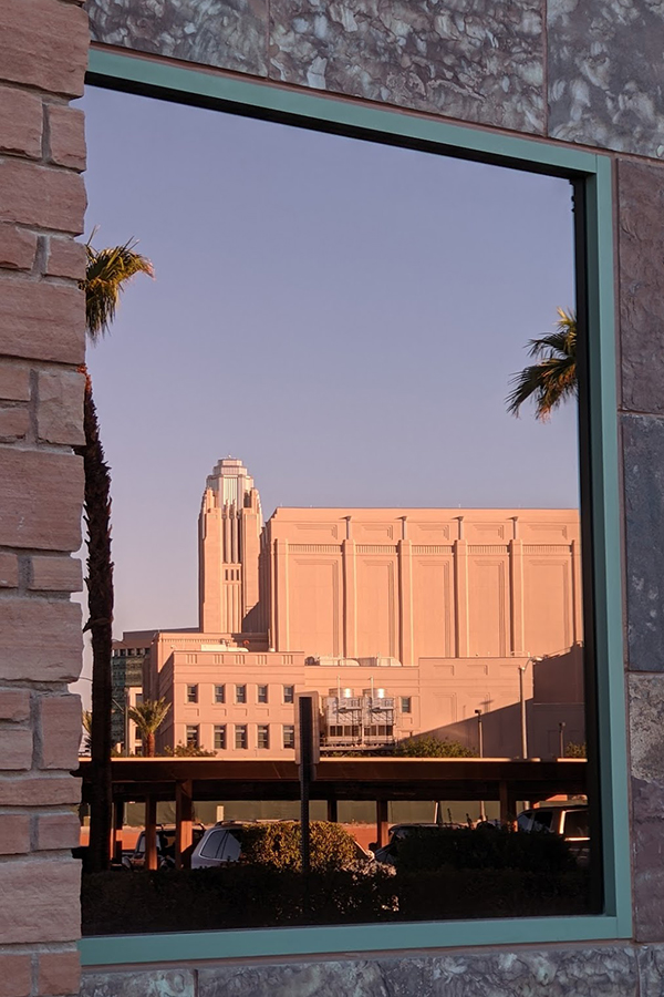 Smiths Center reflected in City Hall window.